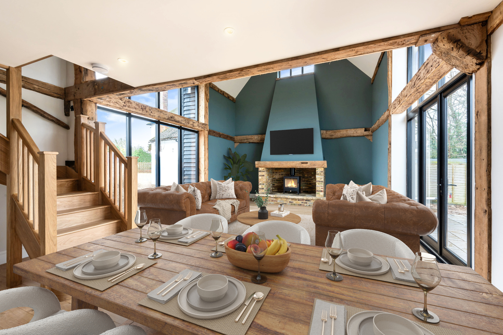 Undressed barn conversion interior with bare floors and empty fireplace